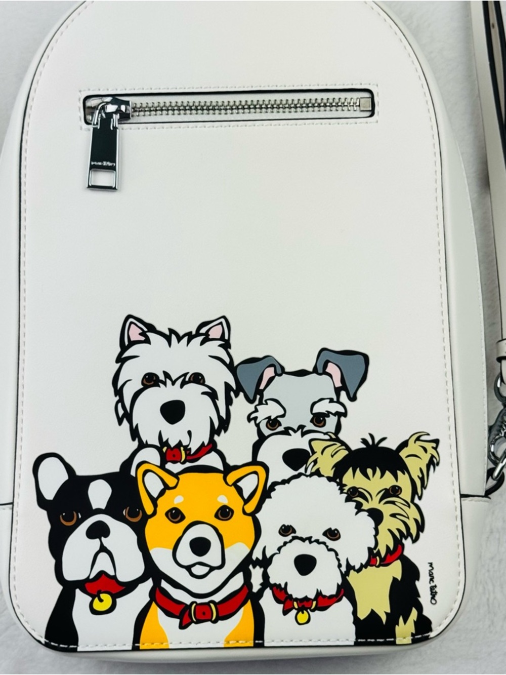 Marc Tetro mini backpack featuring a graphic illustration of various dog breeds